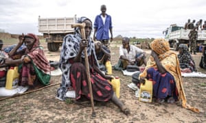 People receive food aid containing rice, sugar, flour and oil distributed at Kasaba and Qasali refugee camps in Mogadishu, Somalia on May 17, 2019.