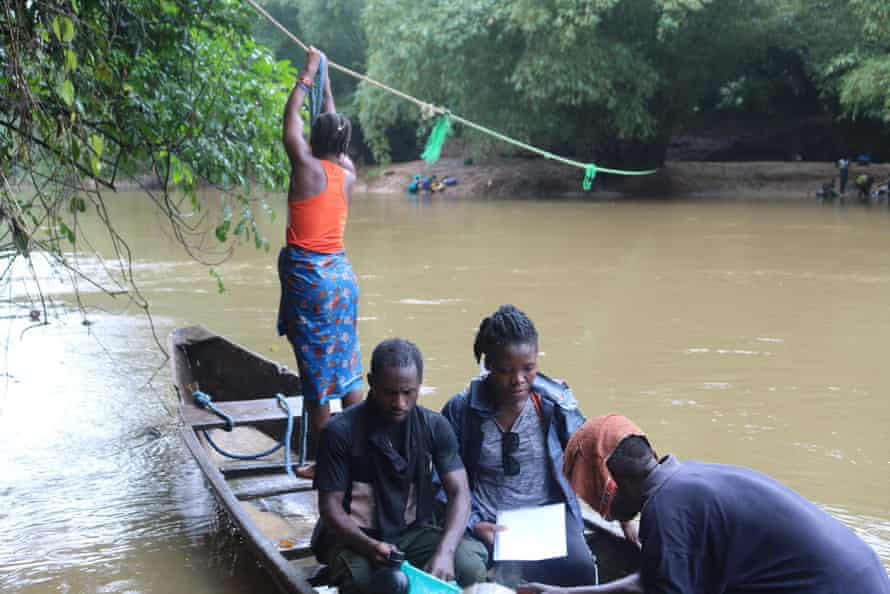 A conservation team collects environmental DNA from the Dubo River, Liberia. This method of sampling is much quicker than traditional surveying techniques.