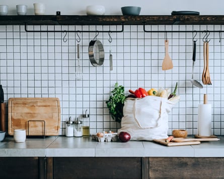 A reusable bag full of colourful and fresh organic vegetables and groceries on the kitchen counter. Zero waste shopping and sustainable lifestyle concept