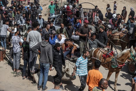 Thousands of Palestinians displaced by Israeli forces gather in the coastal area of Deir al-Balah in the morning to cross to the northern Gaza Strip on April 14, 2024.