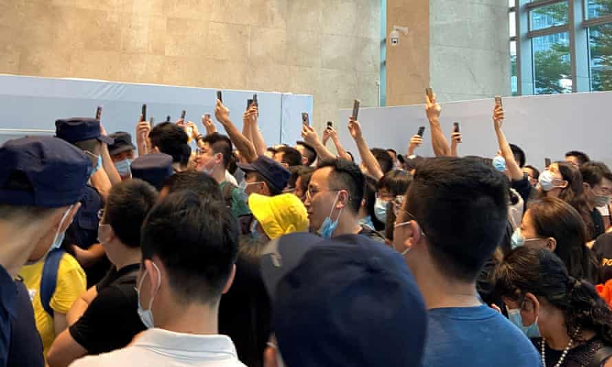 People demand repayment of loans and financial products at Evergrande's Shenzhen headquarters.