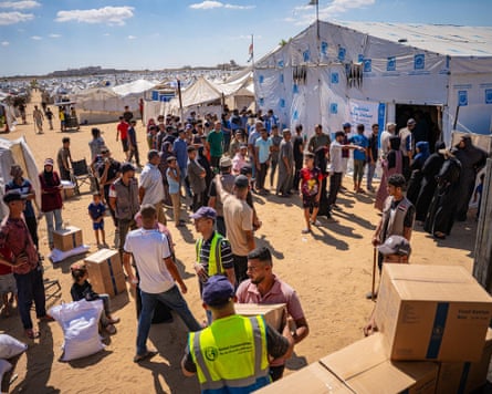 People outside a large aid tent