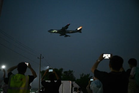 People gather to get a view of Air Force One, carrying US president Donald Trump, arriving at Beijing Capital Airport.