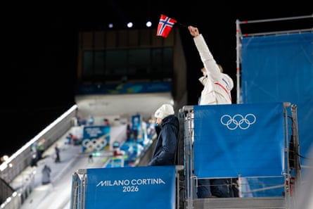 A Norway coach uses a flag to signal when it’s good to jump.