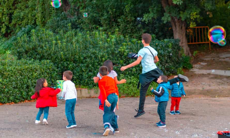 Children play with bubbles in Barcelona, Spain.
