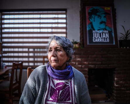 An older Hispanic woman in a home, looking sadly to one side