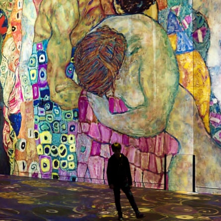 Visitor looks at a huge digital projection of Klimt's Death and Life.