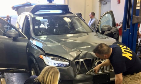 Investigators examine the Uber vehicle involved in the crash in Tempe, Arizona.