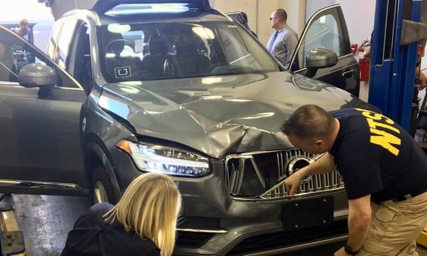 Federal investigators examine the self-driving Uber vehicle involved in a fatal accident in Tempe, Arizona.