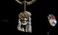 gold chain necklace with face of man with diamond beard, long hair and gold crown