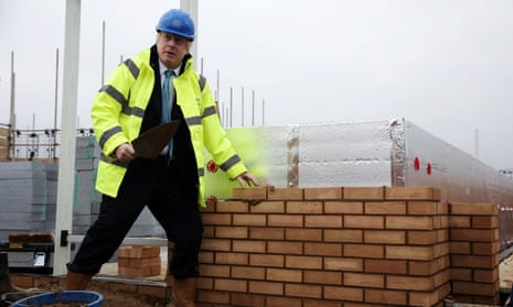 Boris Johnson lays a brick during a visit to a Barratt Homes development in Bedford, last November. The prime minister has backed plans to allow buildings to be repurposed without full planning permission.