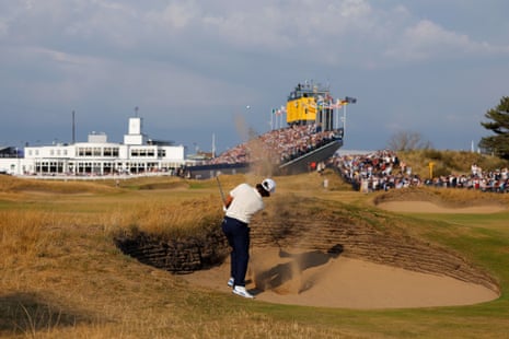 Tommy Fleetwood plays a shot from a bunker on the 18th.