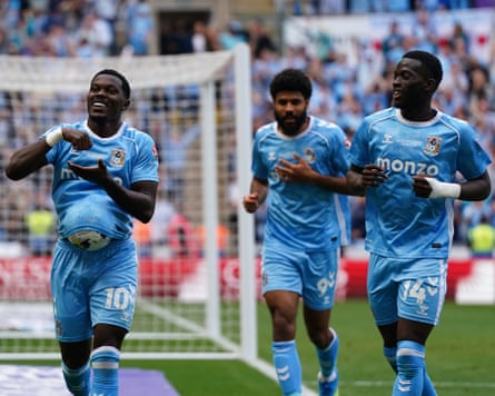 Ephron Mason-Clark puts the ball up his top as he celebrates scoring his team’s third goal against Wrexham