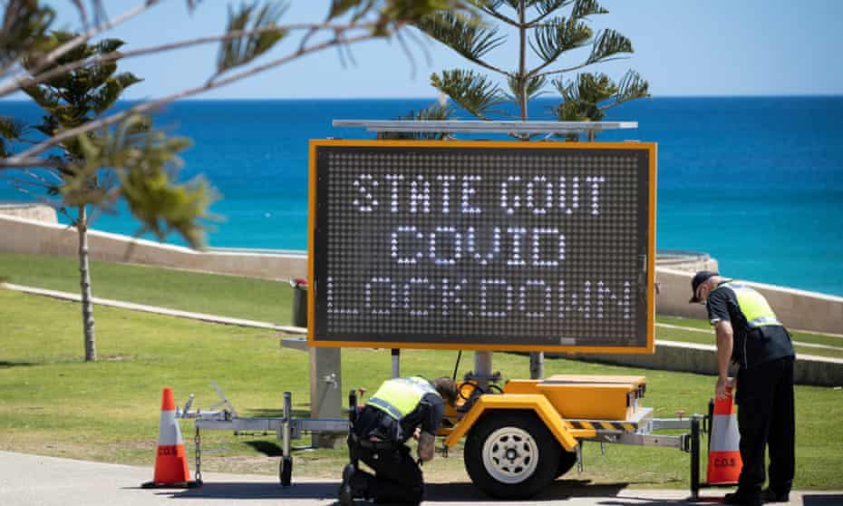Covid sign being set up on a Perth beach