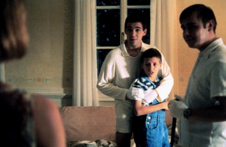 a man with his arms around a boy