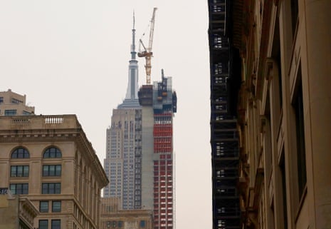 view of thin building under construction in front of empire state building