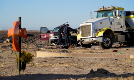 Law enforcement investigators inspect the scene of a deadly crash on State Highway 115 near the US-Mexico border. 