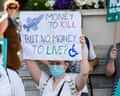 Disability protesters hold up banners