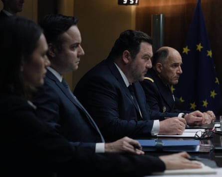 Still from Jupiter in which Ménochet and other actors are in the situation room