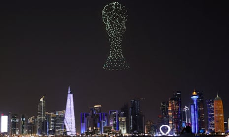 Drone lights depict the World Cup trophy over Doha before the tournament kicks off this Sunday.