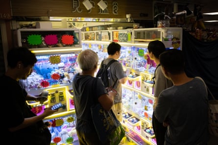 People playing claw machines in Kwai Chung Plaza
