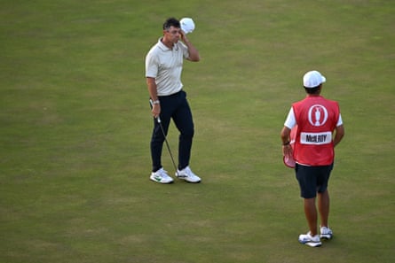 Rory McIlroy lifts his headdress pinch putter successful manus connected nan 18th greenish astatine Royal Birkdale
