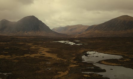 The Scottish Highlands, showing a lake and mountains with dark clouds over head