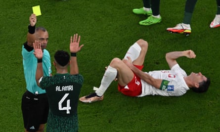 Wilton Sampaio books Saudi Arabia’s Abdulelah Alamri for a foul on Poland’s Robert Lewandowski during the Qatar 2022 World Cup Group C match.