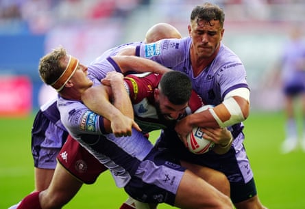 Abbas Miski is tackled by Jai Whitbread and Jez Litten as Hull KR produced a defensive masterclass against Wigan.