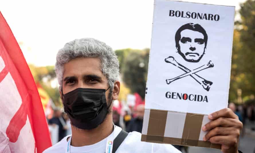 A protester holding a placard against Jair Bolsonaro during a protestation  against the G20 connected  the sidelines of the leaders acme  connected  30 October.