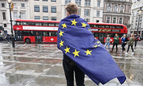 demonstrator wrapped in EU flag leaving an anti-Brexit protest