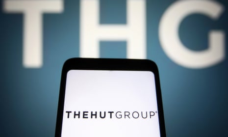 THG PLC (The Hut Group) logo  on a smartphone and a pc screen.