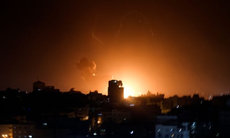 Fire and smoke rise above buildings in Gaza City as Israel launched airstrikes on the Palestinian enclave early on Thursday