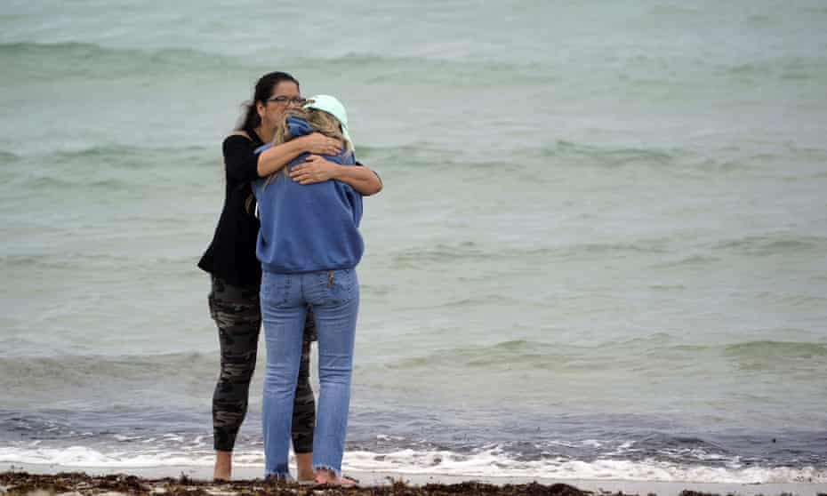 People console each other near the site of the collapse.