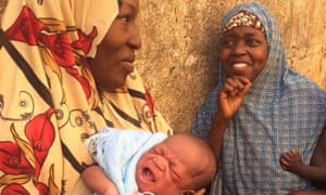Binta Siddique, left, and Hanza Absulane await anti-polio vaccinations for their babies.