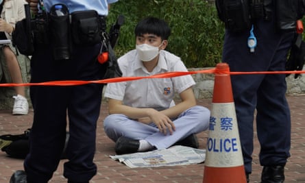 A protester waits outside a court for the prison van carrying a pro-independence supporter who was denied bail after being charged with secession under the Hong Kong’s national security law.
