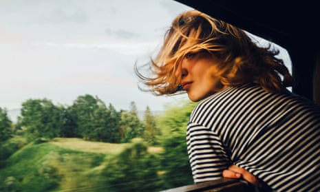 woman looking at the view from train window