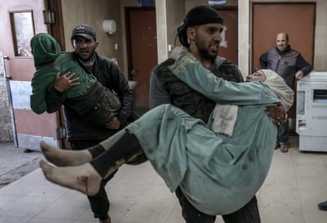 Palestinians injured in an Israeli attack are taken to al-Aqsa Martyrs hospital in Deir Al Balah, Gaza on Friday.