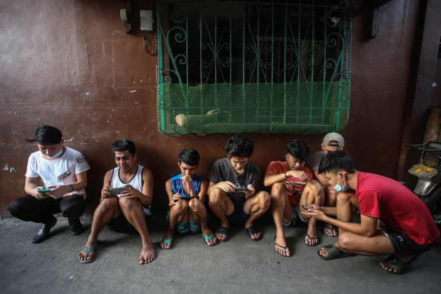 People playing NFT game Axie Infinity in Manila.