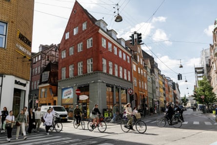 Copenhagen street scene shows people cycling and walking.