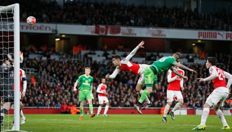 Sunderland’s Steven Fletcher beats Arsenal’s Gabriel Paulista to the ball but smacks his header against the bar.