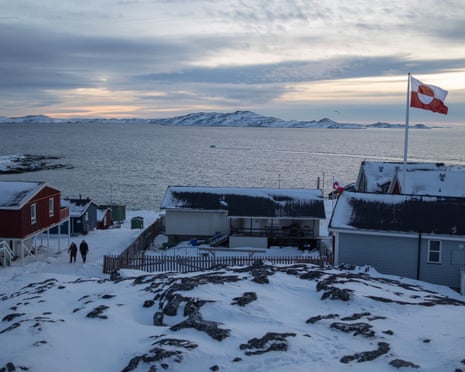 A Greenland flag flies as people walk on the day of a meeting between top US officials and the foreign ministers of Denmark and Greenland, in Nuuk, Greenland.