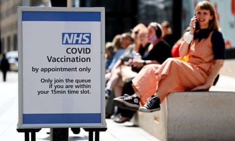 Young people queue outside a Covid vaccination centre in London