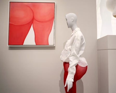 A corpulent dressed female mannequin next to a painting of a naked bottom