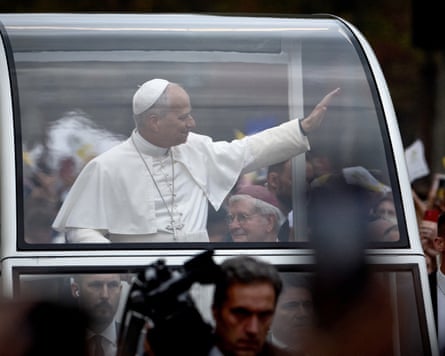 Pope Leo greets crowds lining the Champs-Élysées on the second day of his visit to France
