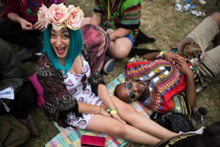 Fans rest on the grass in front of the Pyramid Stage at the Glastonbury Festival