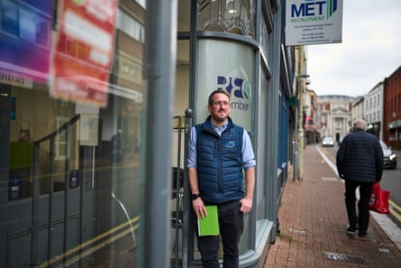 A man stands outside MET UK’s office on a high street