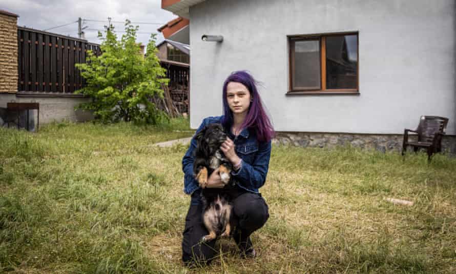 Anastasiya Tikha with one of her dogs in her garden. 