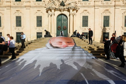 Image of a sleeping baby is projected on to steps outside an old building in Malta