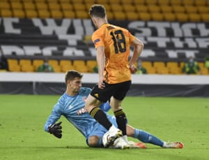 Olympiakos’ goalkeeper Bobby Allain, left, stops a shot from Wolverhampton Wanderers’ Diogo Jota.